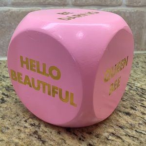 Inspirational pink dice cube with six quotes.